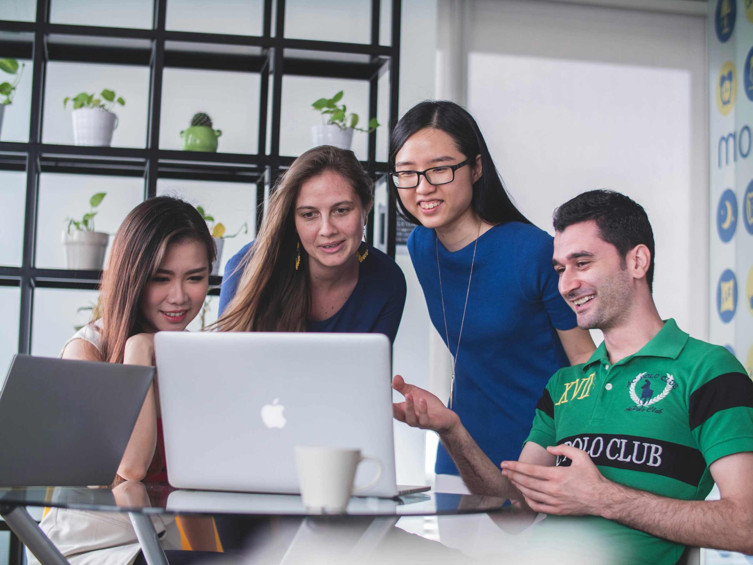 work group gathered around computer