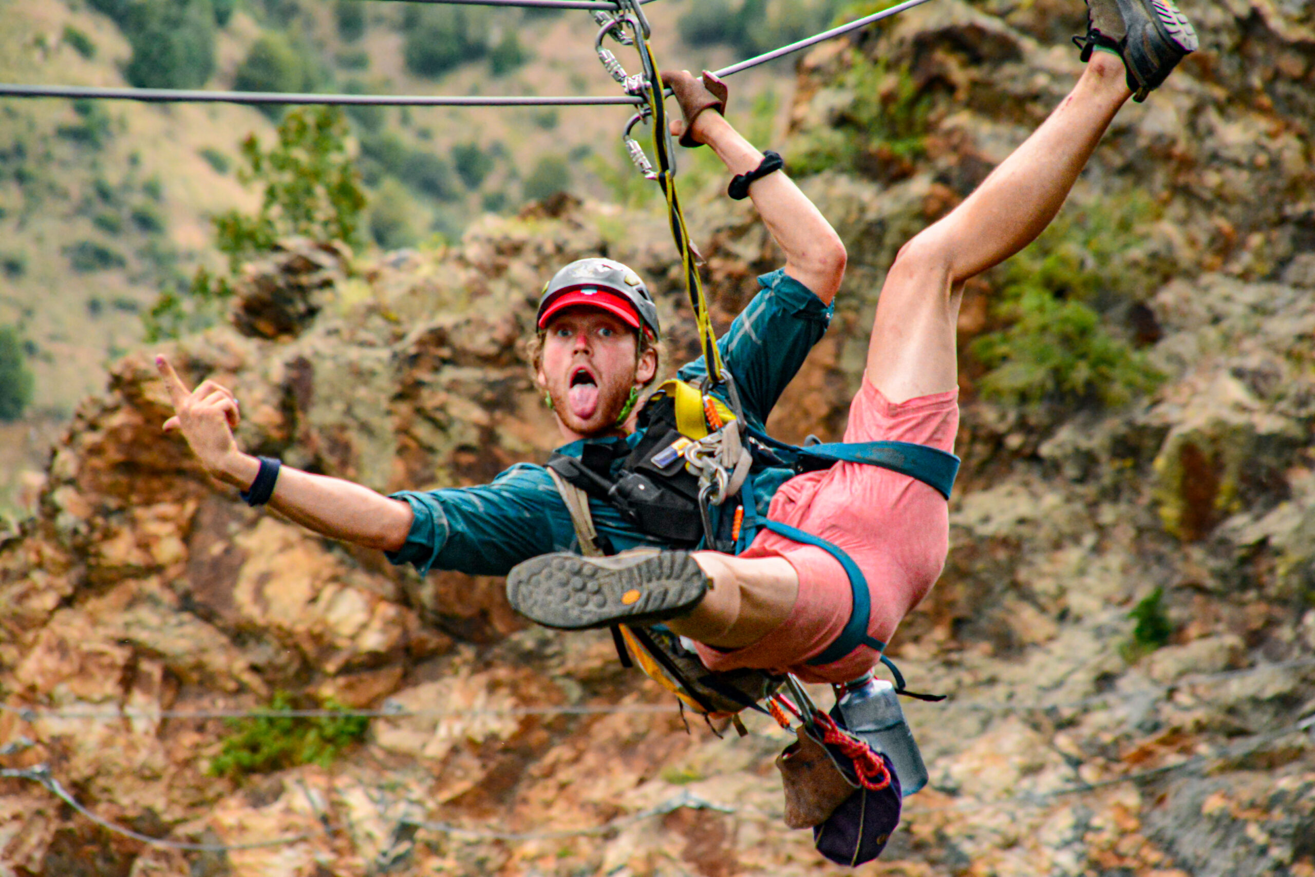 man ziplining in fall