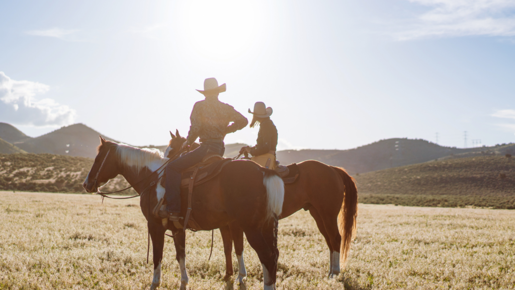 Two people on horseback in the Arkansas River Valley, Colorado.