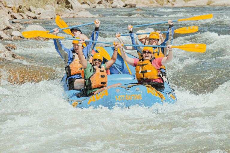 River rafting group with oars up for group photo.