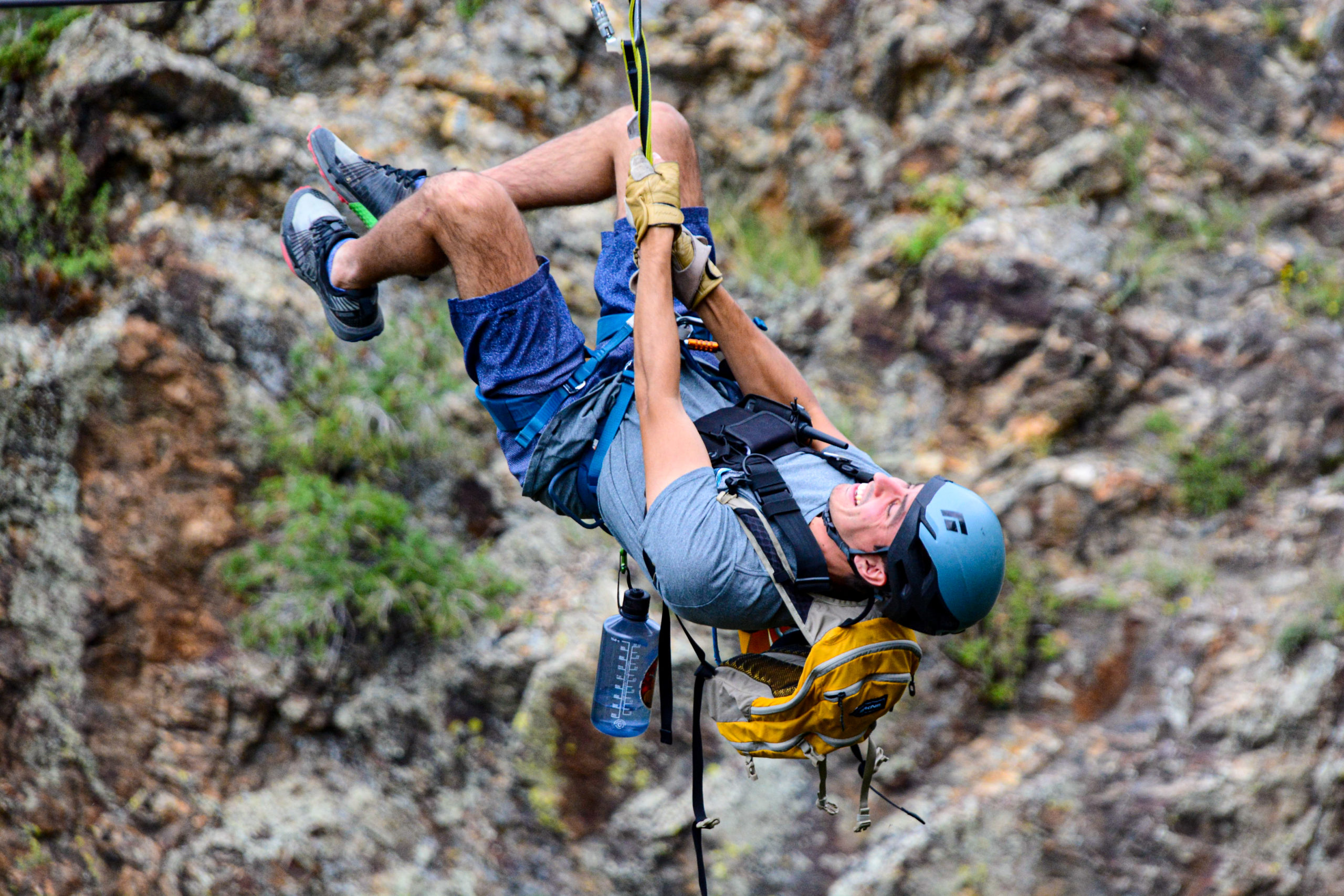 Man hanging upside down while ziplining in Colorado