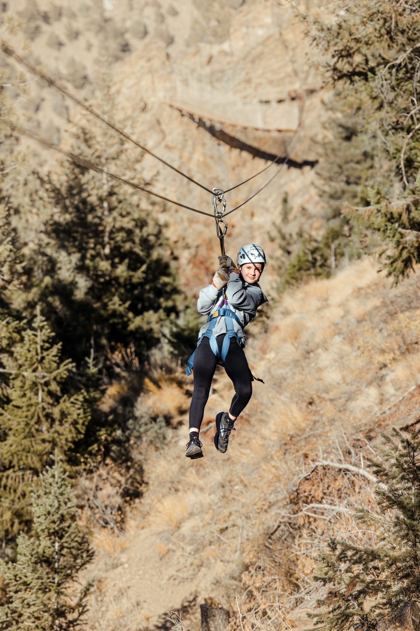 girl zipping through trees