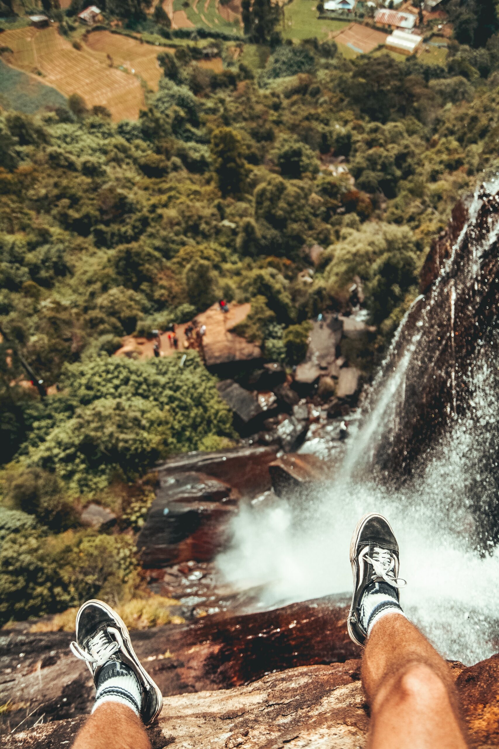 person's feet hanging over ledge