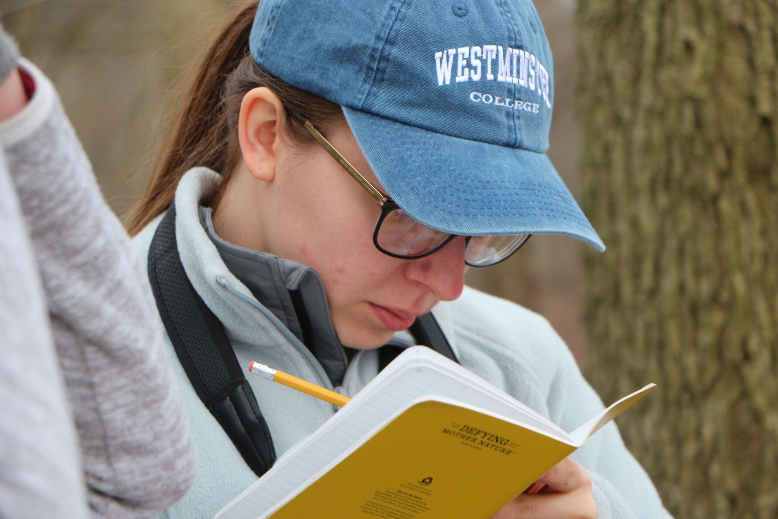 Woman taking notes in field journal