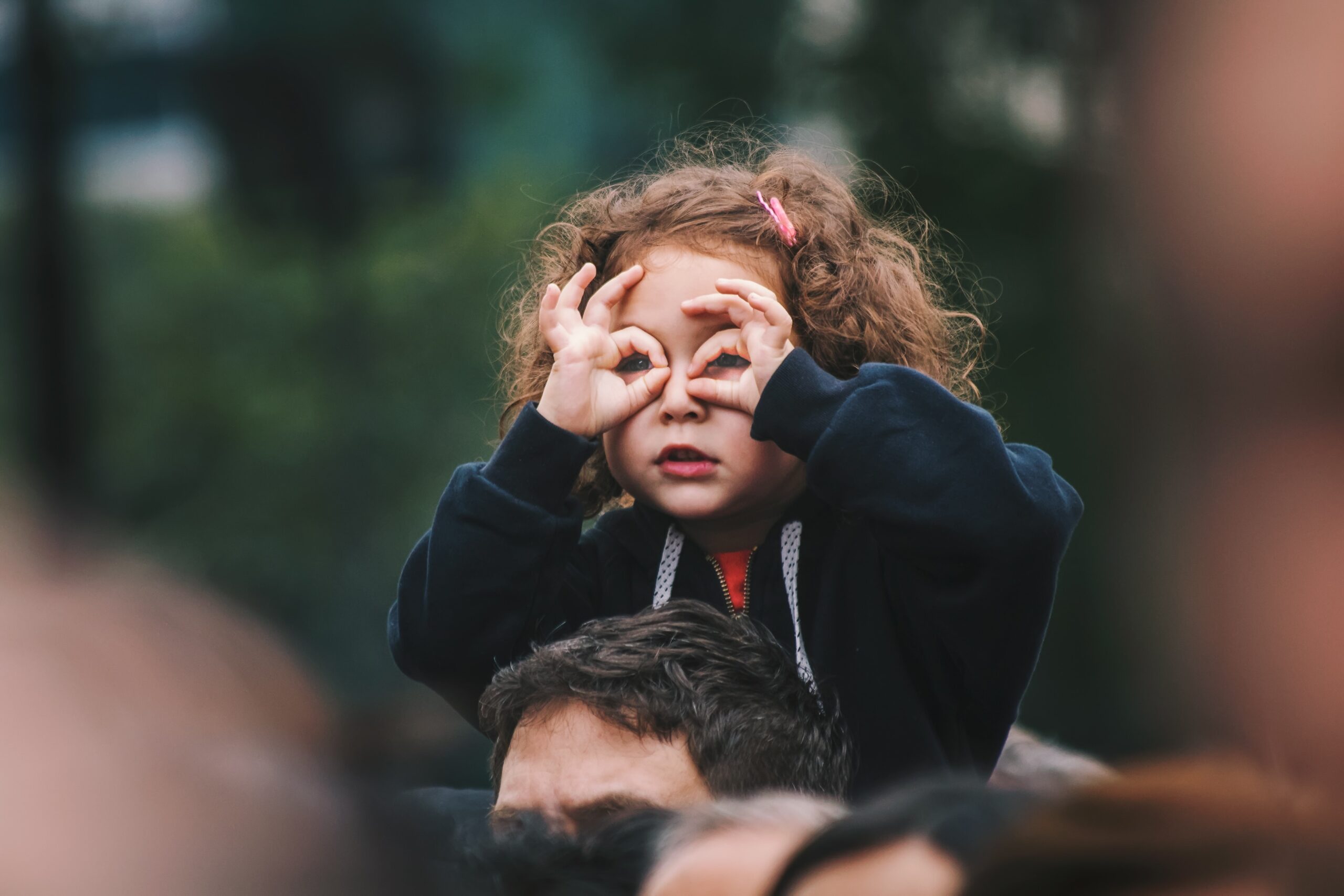 Girl putting fingers around eyes