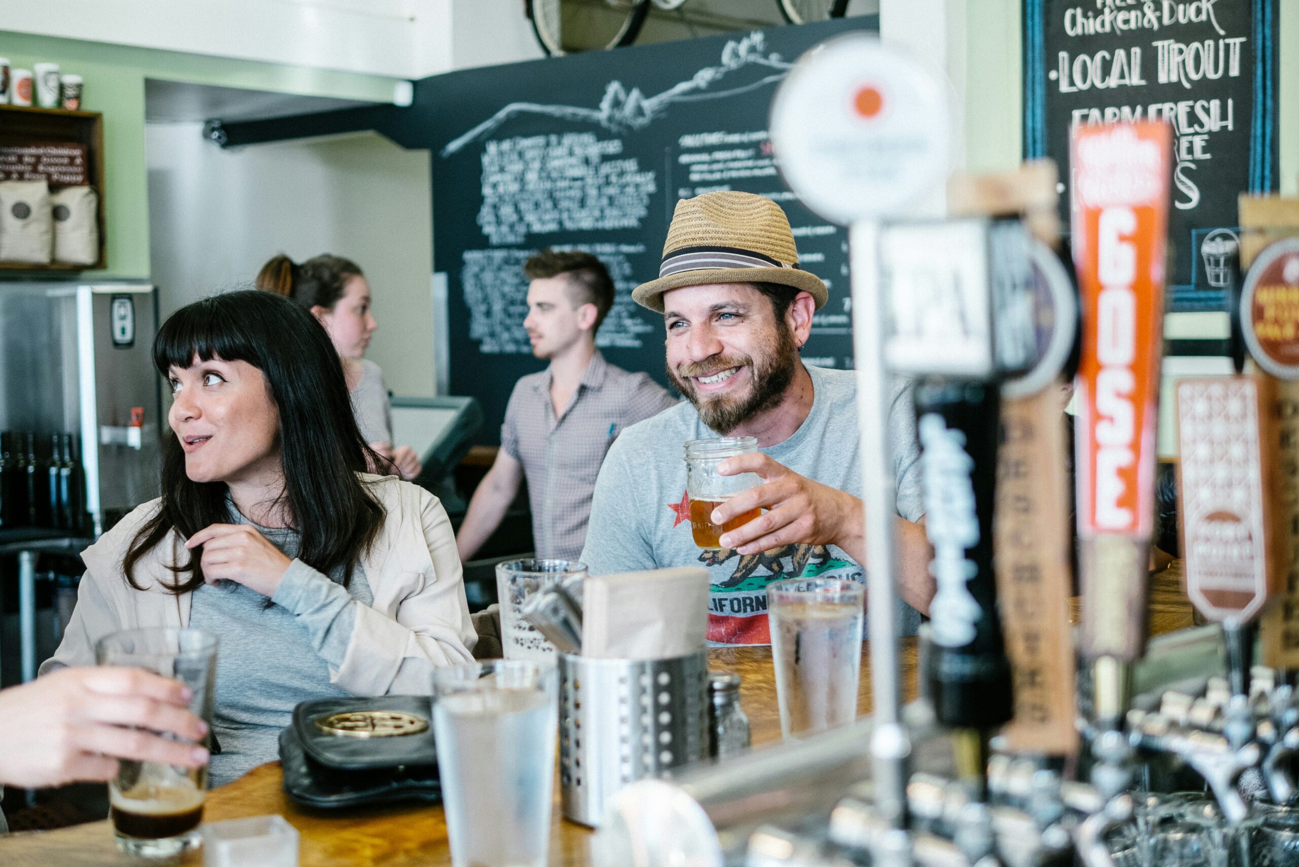 man and woman enjoying themselves at brewery