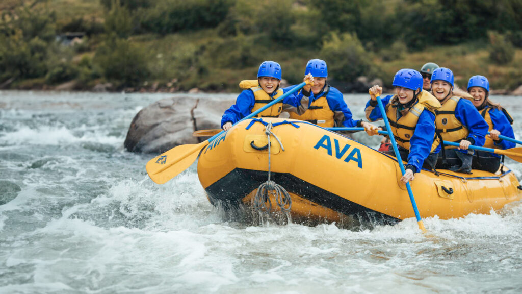 Tour guide rafting with a group.