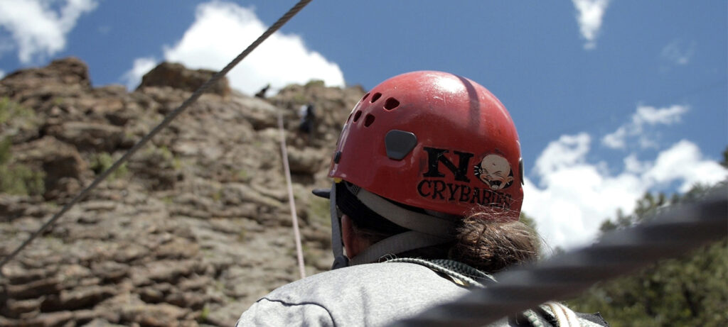 Spotter watching someone on a Via Ferrata course.