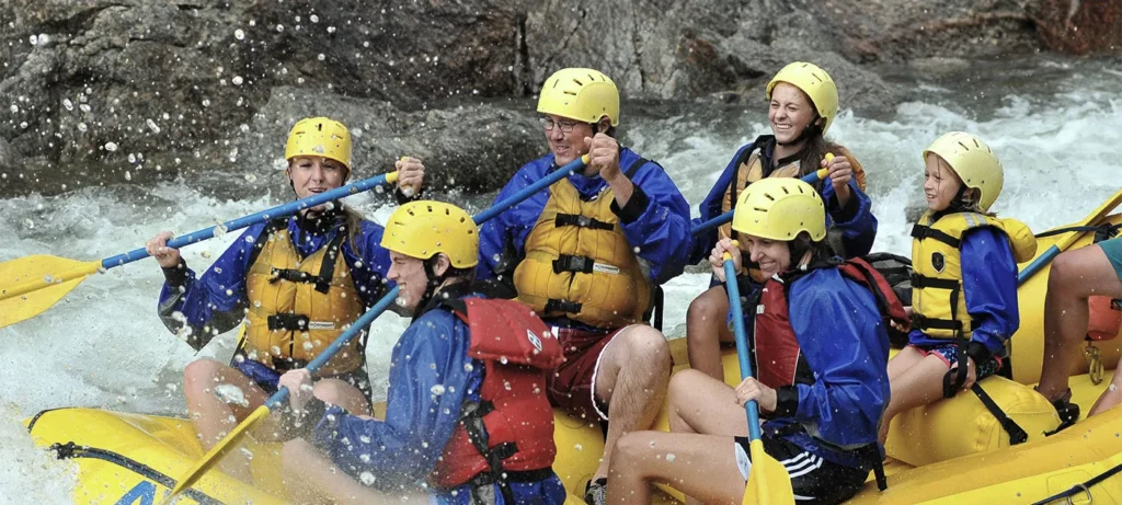 Group traversing white water while rafting.