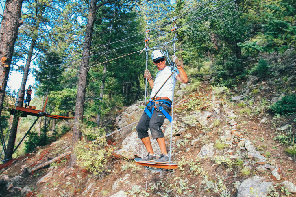 Man on a zipline course in Colorado.